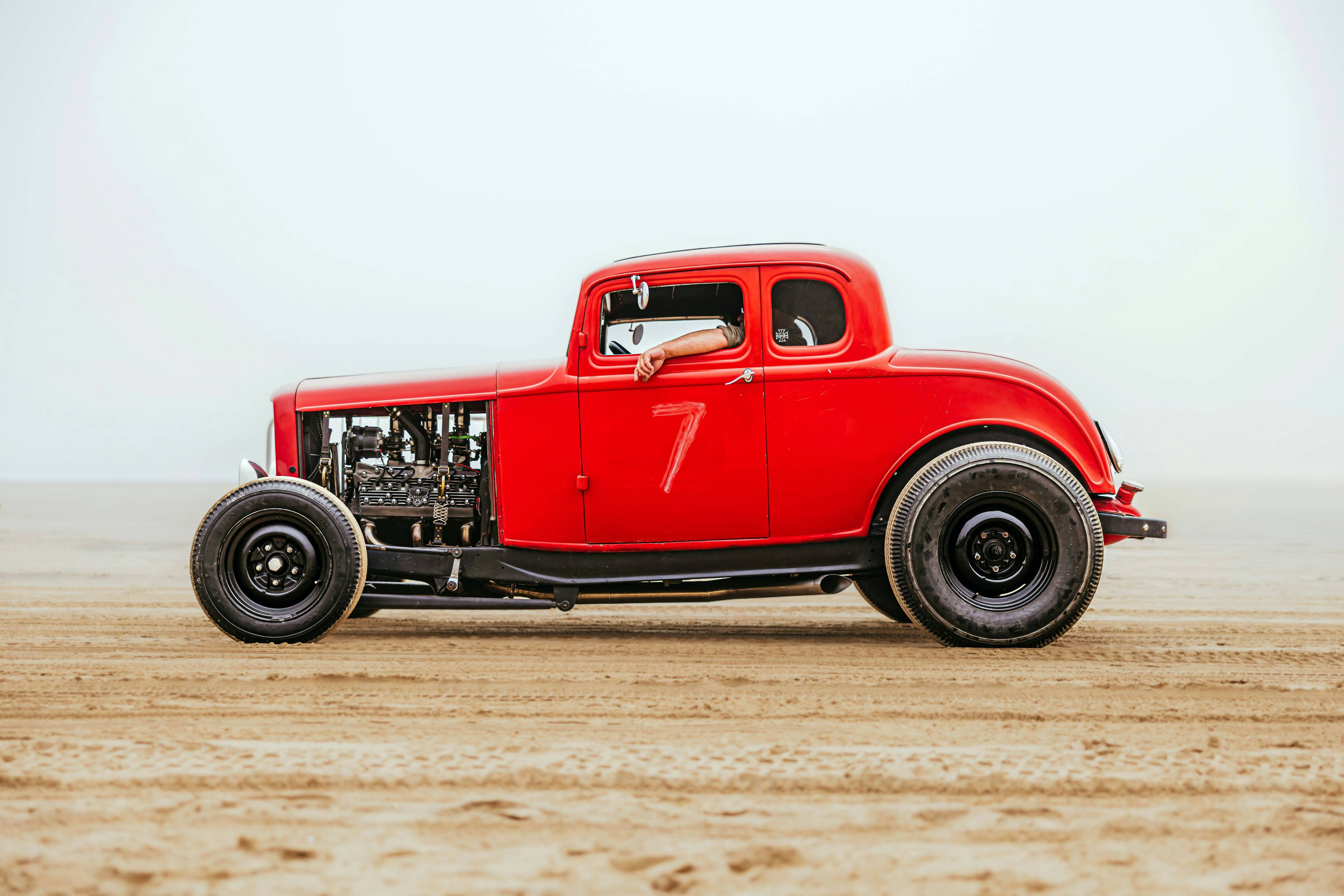 a red truck parked on top of a dirt field