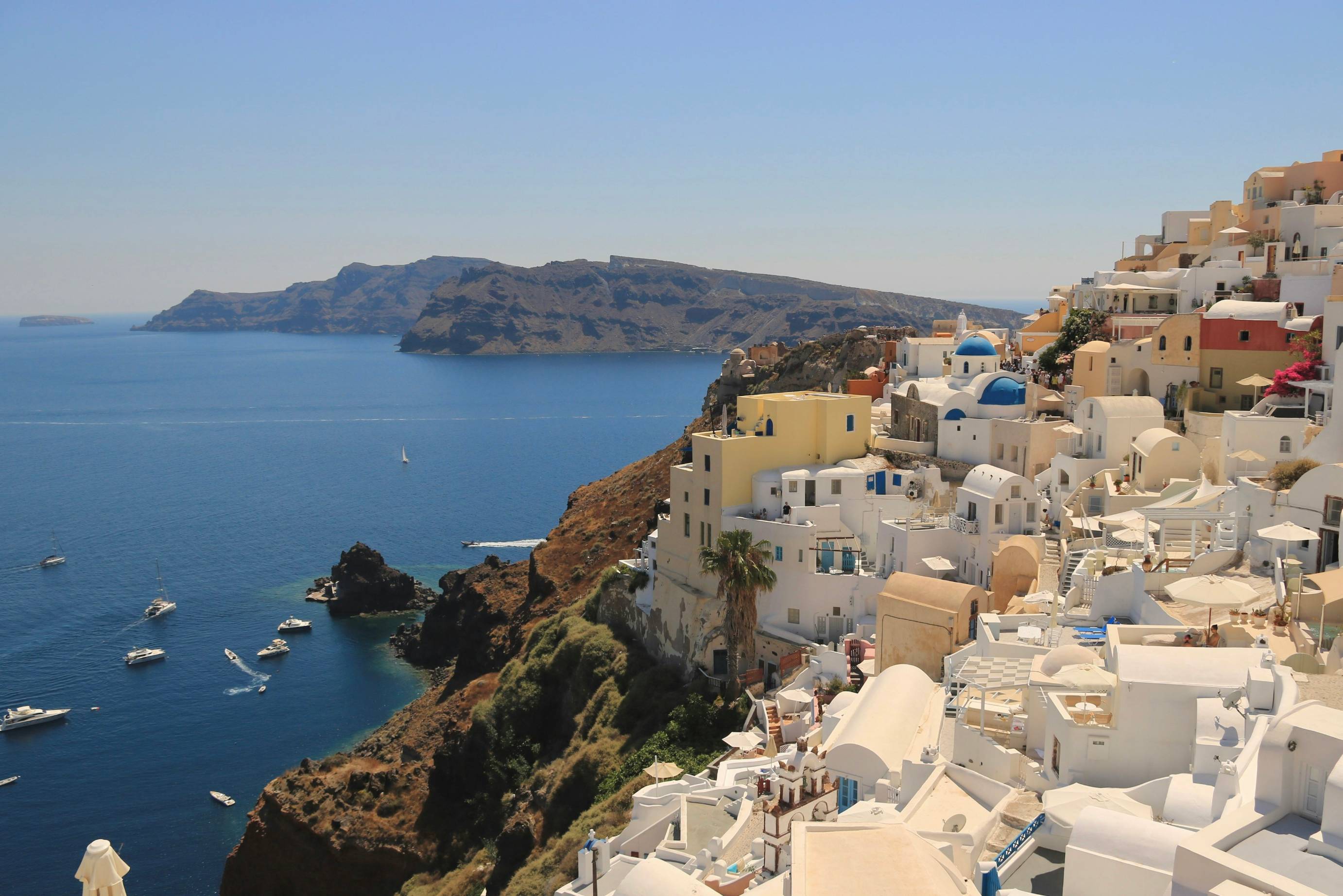 a view of a village on a cliff overlooking the ocean