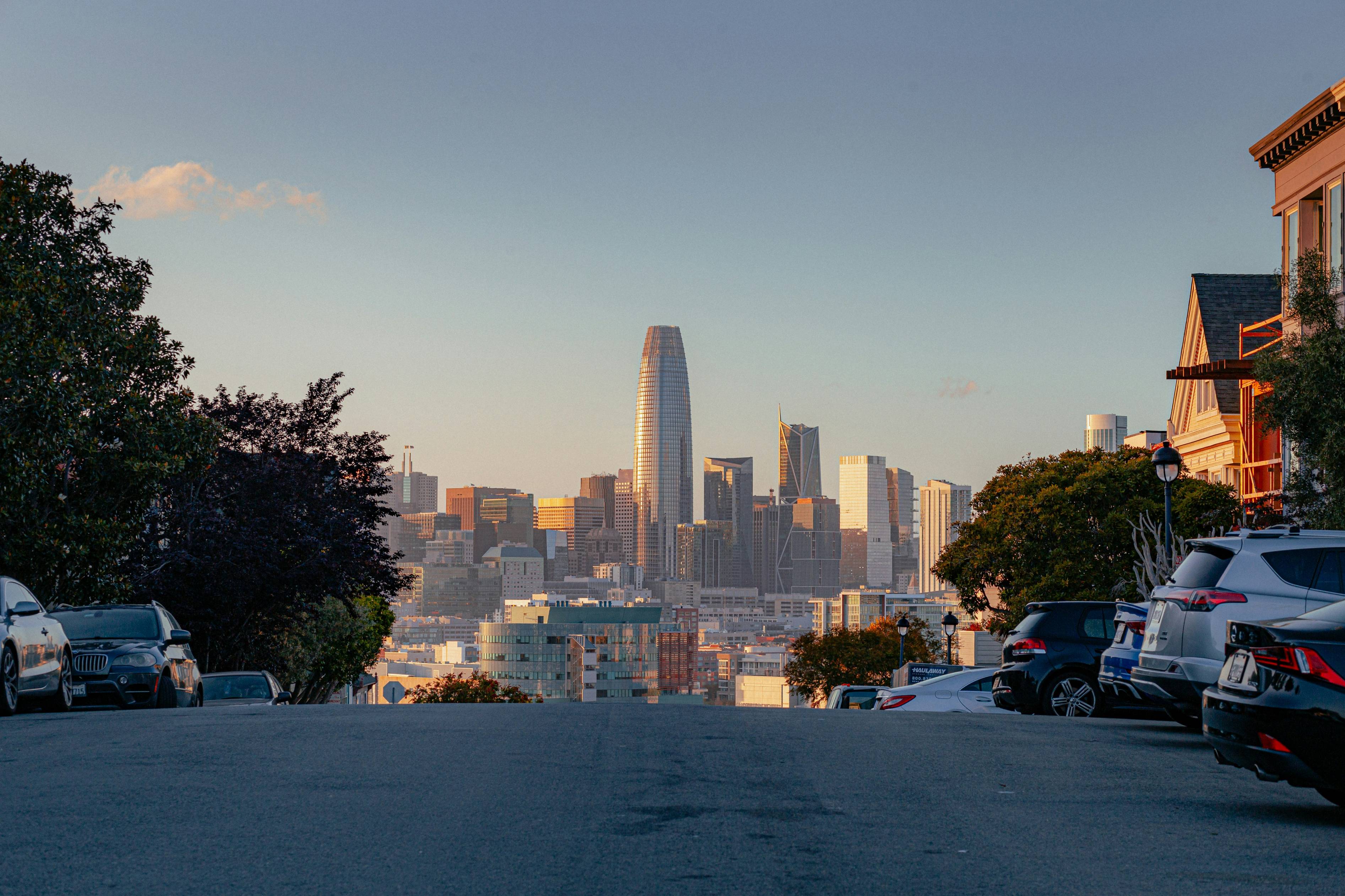 a city skyline with cars parked in front of it
