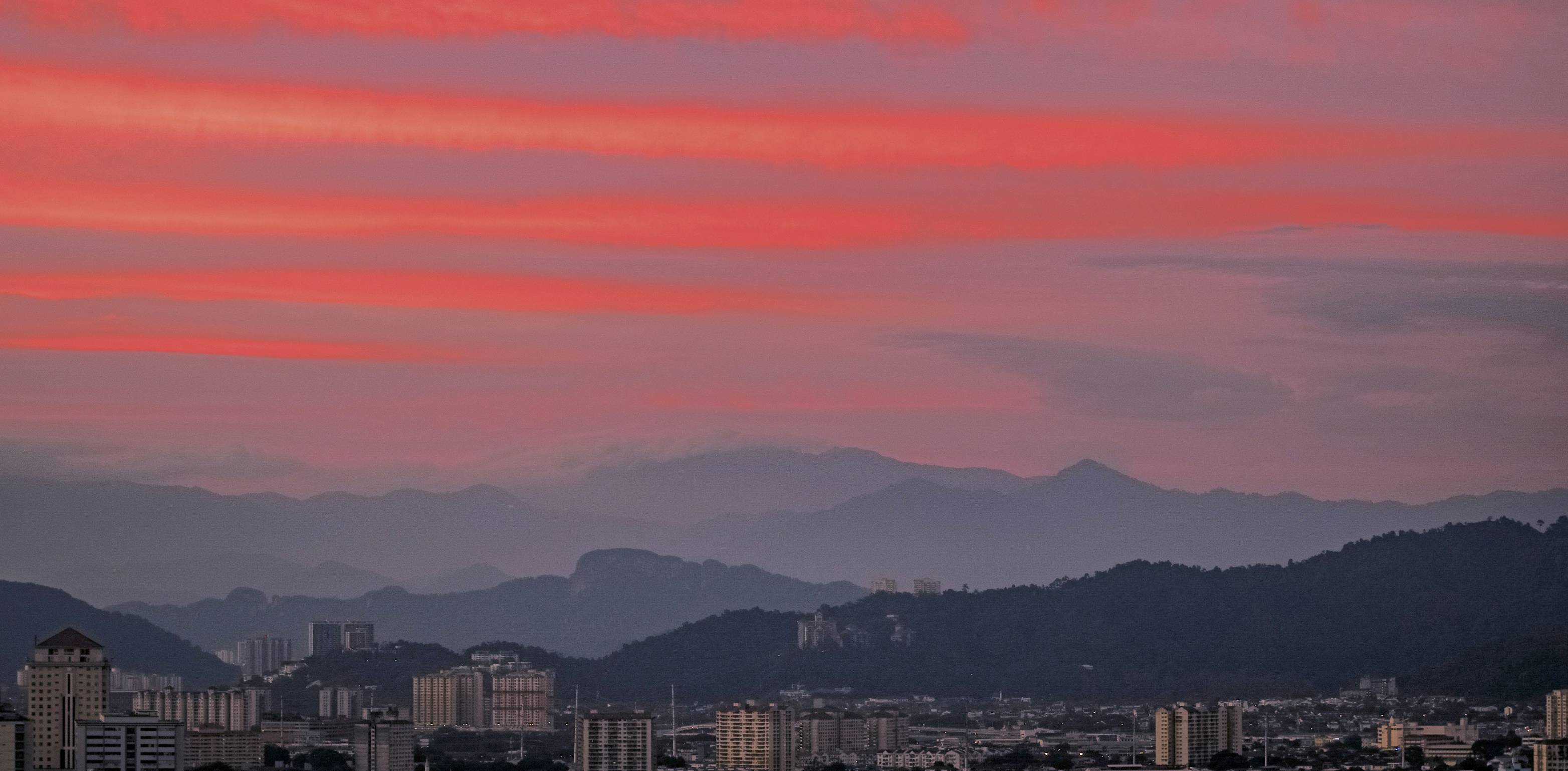 a view of a city with mountains in the background